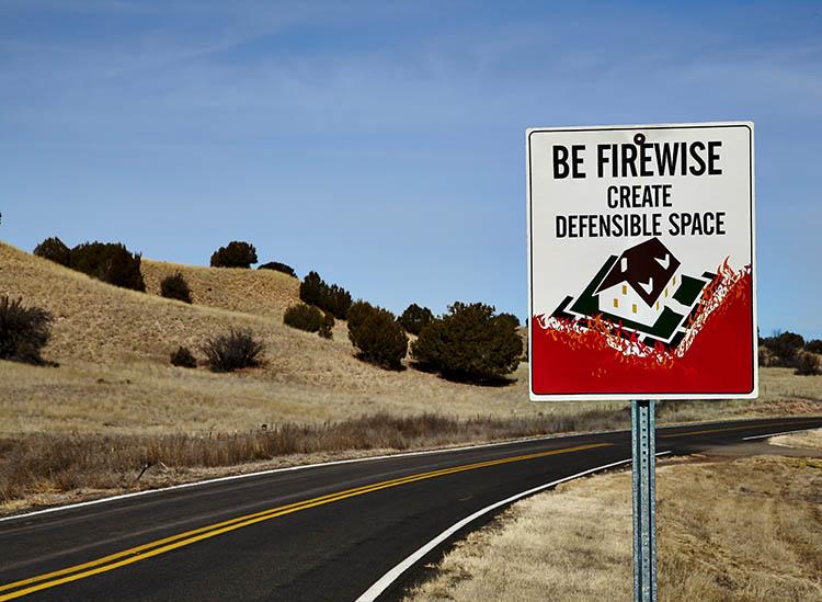 Road sign for wildfire defensible space